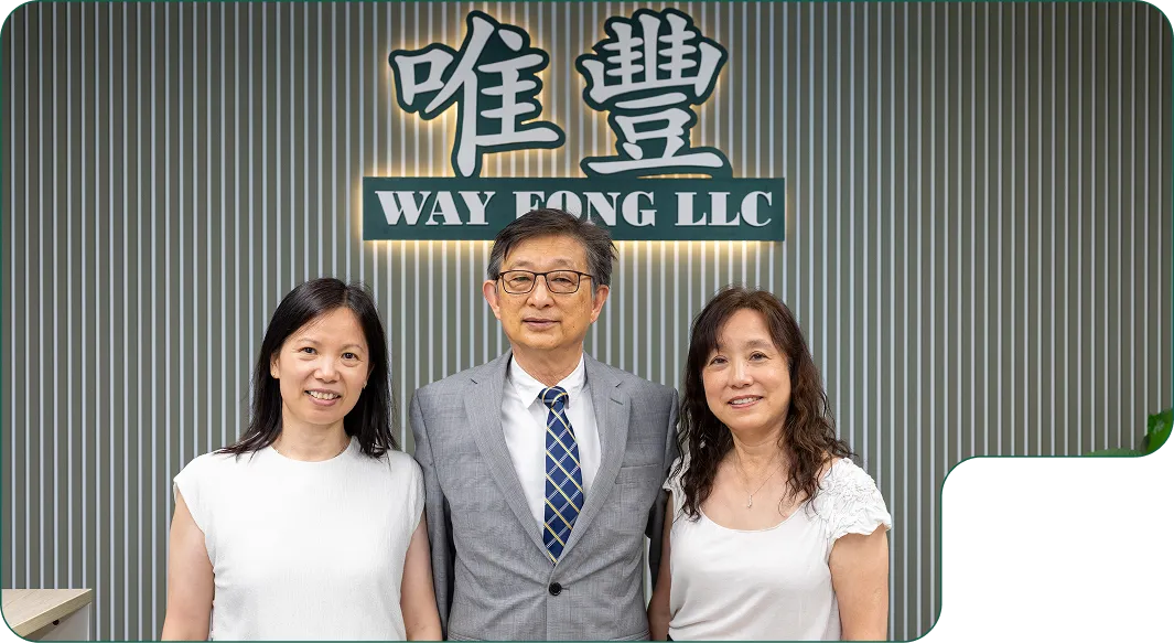 Way Fong Employees posing in front of the Way Fong Logo